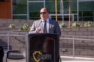 Supervisor Hagman standing at podium speaking at grand opening of the new public defender building.