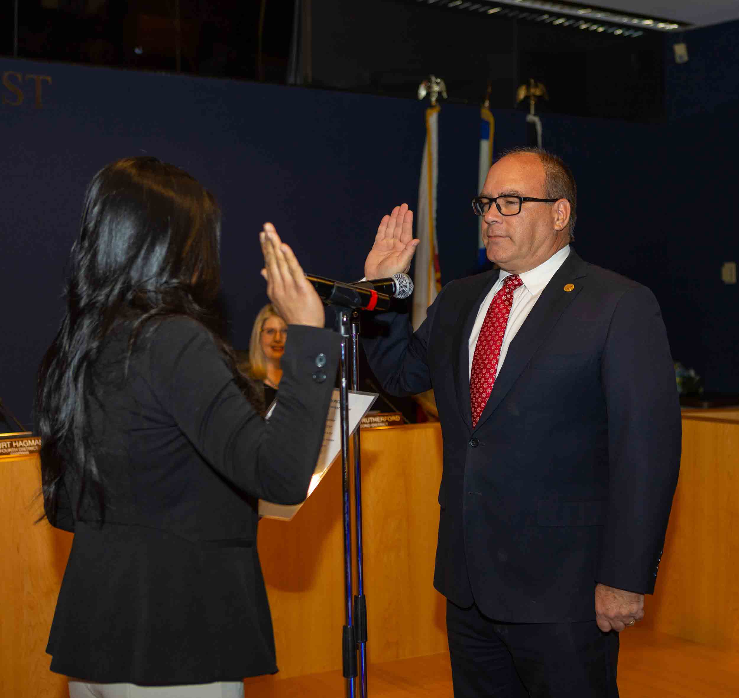 Supervisor Hagman taking his oath of office from his wife, Rossana.