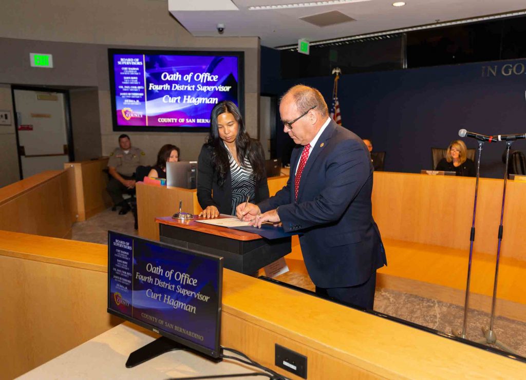 Supervisor Hagman signing his oath of office certificate