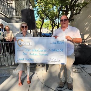 Supervisor Hagman presenting the Chino Valley Chamber of Commerce with a large check in the amount of $100,000.