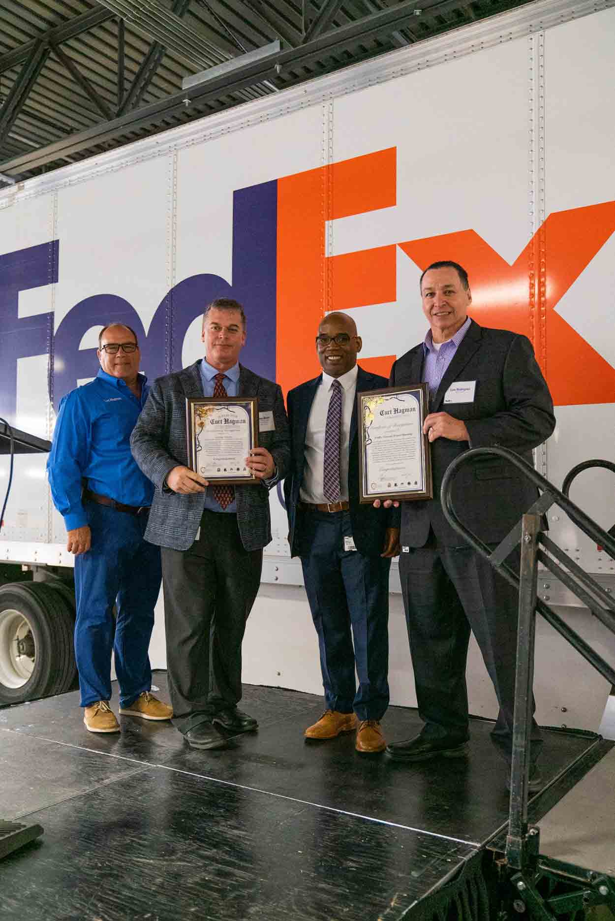 Supervisor Hagman presents two certificates to the FedEx Leadership Team.