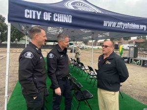 Supervisor Hagman speaking to Chino Police Chief Mensen and another Chino police officer.