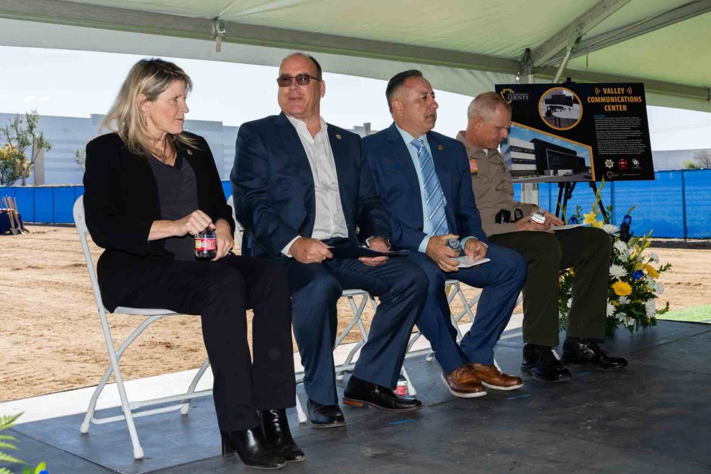 Supervisor Dawn Rowe, Supervisor Curt Hagman, Supervisor Joe Baca Jr., and Sheriff Shannon Dicus sitting on stage during the Valley Communications Center groundbreaking event.