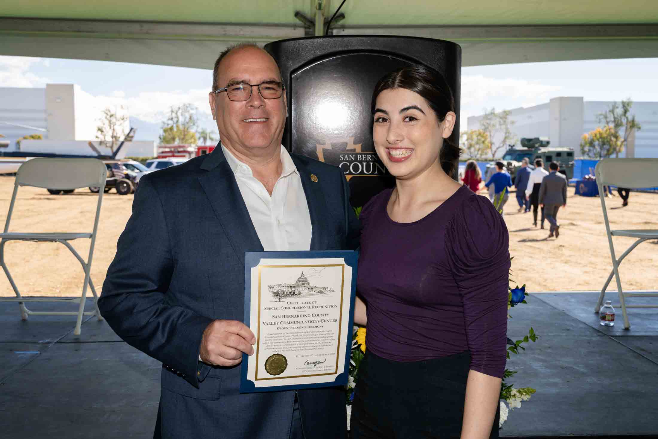 Supervisor Hagman receiving a Certificate of Special Congressional Recognition from Congresswoman Norma Torres' team member.