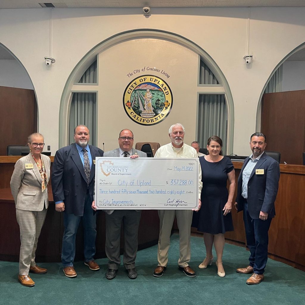 Supervisor Hagman presenting a large check in the amount of $357,288 to the Upland City Council.