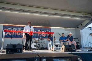 Supervisor Hagman speaking on stage at the Chino Hills Show Wagon Ribbon Cutting