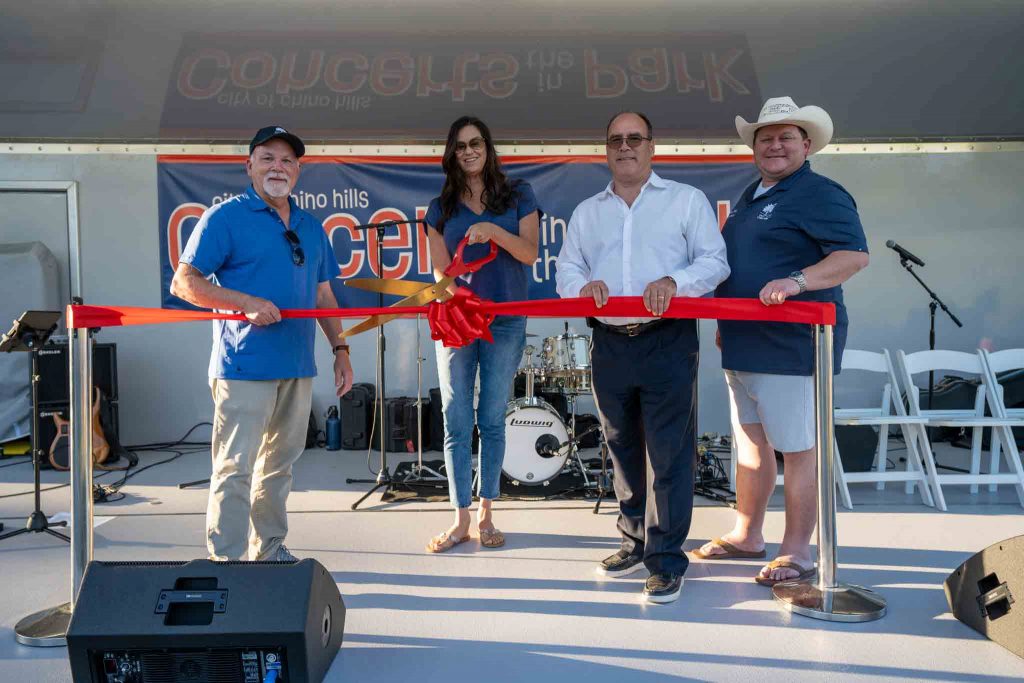 Chino Hills Councilmember Peter Rogers, Mayor Cynthia Moran with scissors about to cut ribbon, Supervisor Curt Hagman, and Chino Hills Councilmember Brian Johsz at the Chino Hills Show Wagon Ribbon Cutting