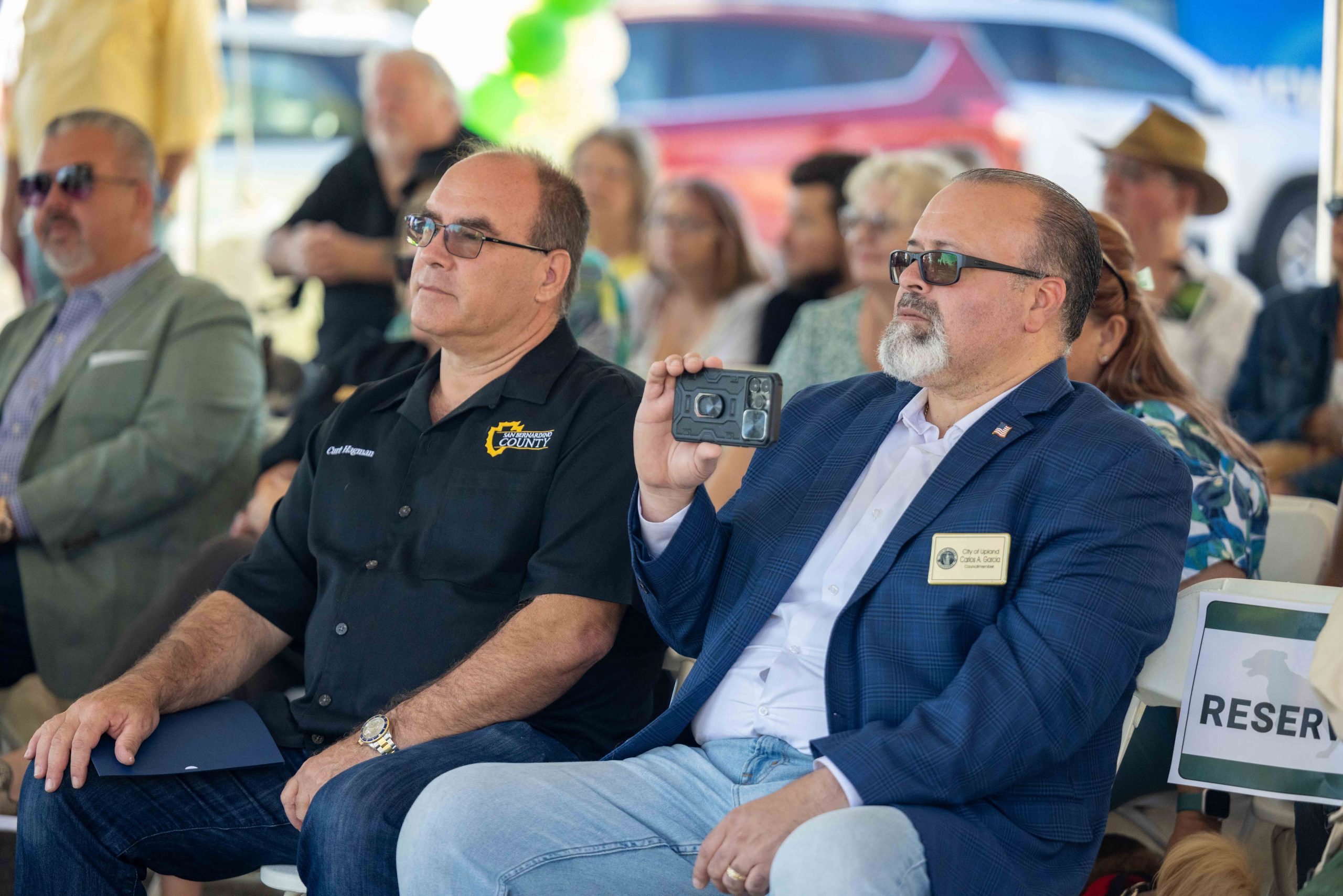 Supervisor Curt Hagman sitting next to Upland Councilmember Carlos Garcia at the Baldy View Dog Park grand reopening event.