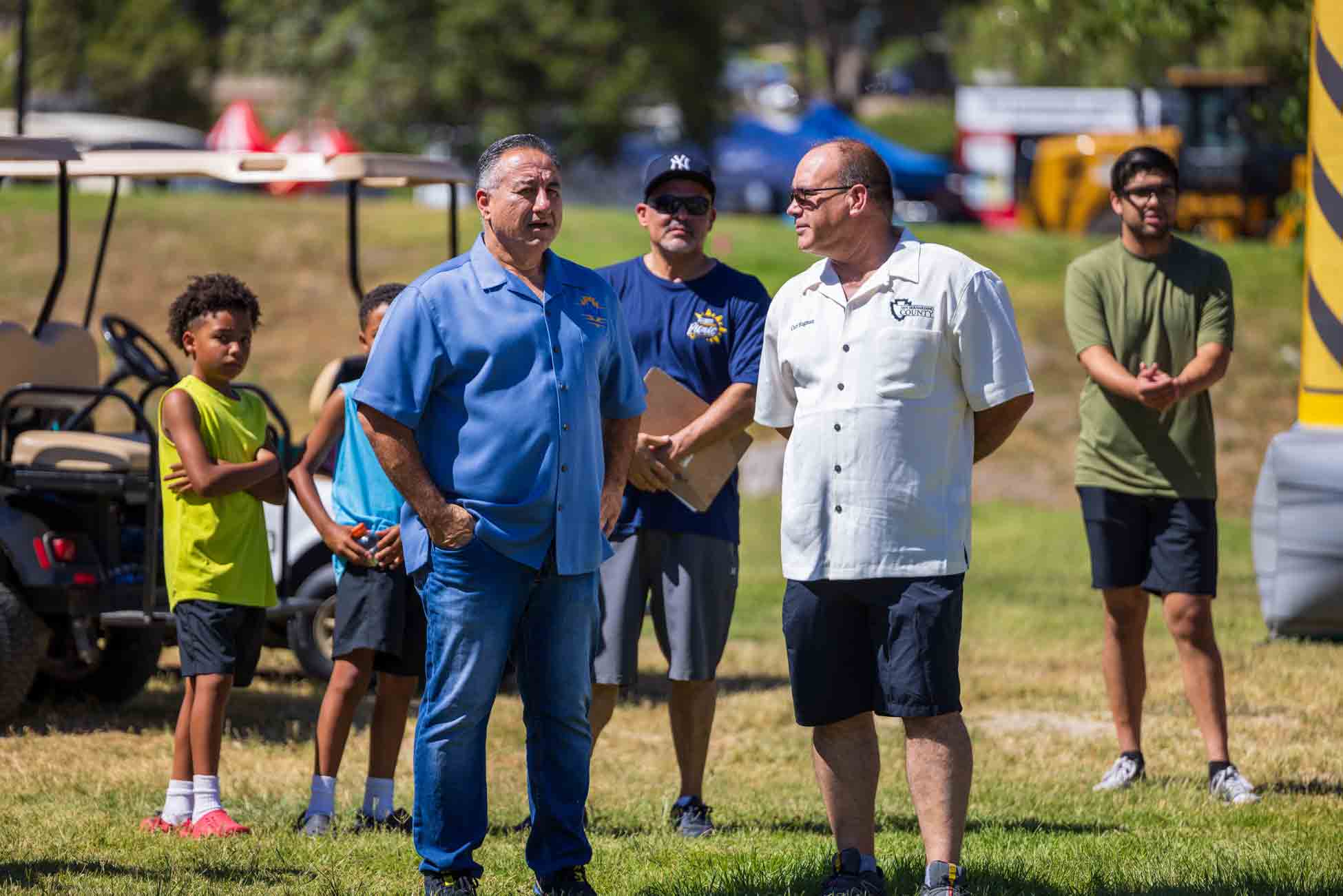 Supervisor Joe Baca Jr. and Supervisor Curt Hagman conversing before the 2024 County Employee Picnic Welcome Remarks.