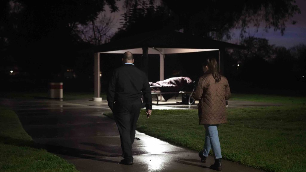 Supervisor Curt Hagman and Chief of Staff Katherine Kolcheva walking through a park in the Fourth District to conduct a Point-in-Time survey on a homeless individual.