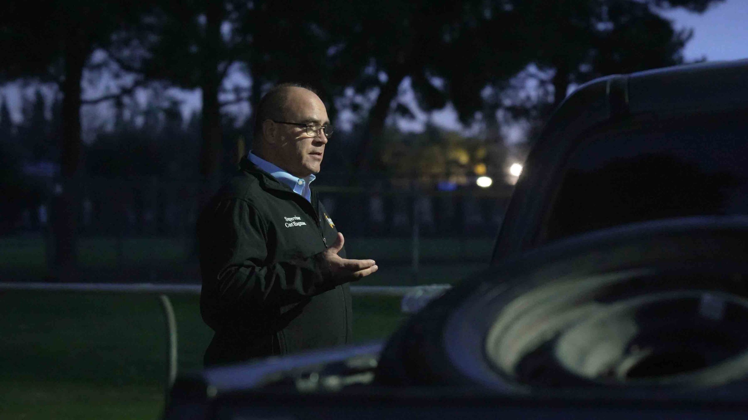 Supervisor Curt Hagman conducting the Point-in-Time survey with an individual who was living in their car.