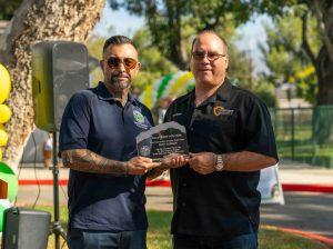 Supervisor Curt Hagman accepting an award from Upland City Councilmember Rudy Zuniga for his generous support of the Baldy View Dog Park Renovation Project.