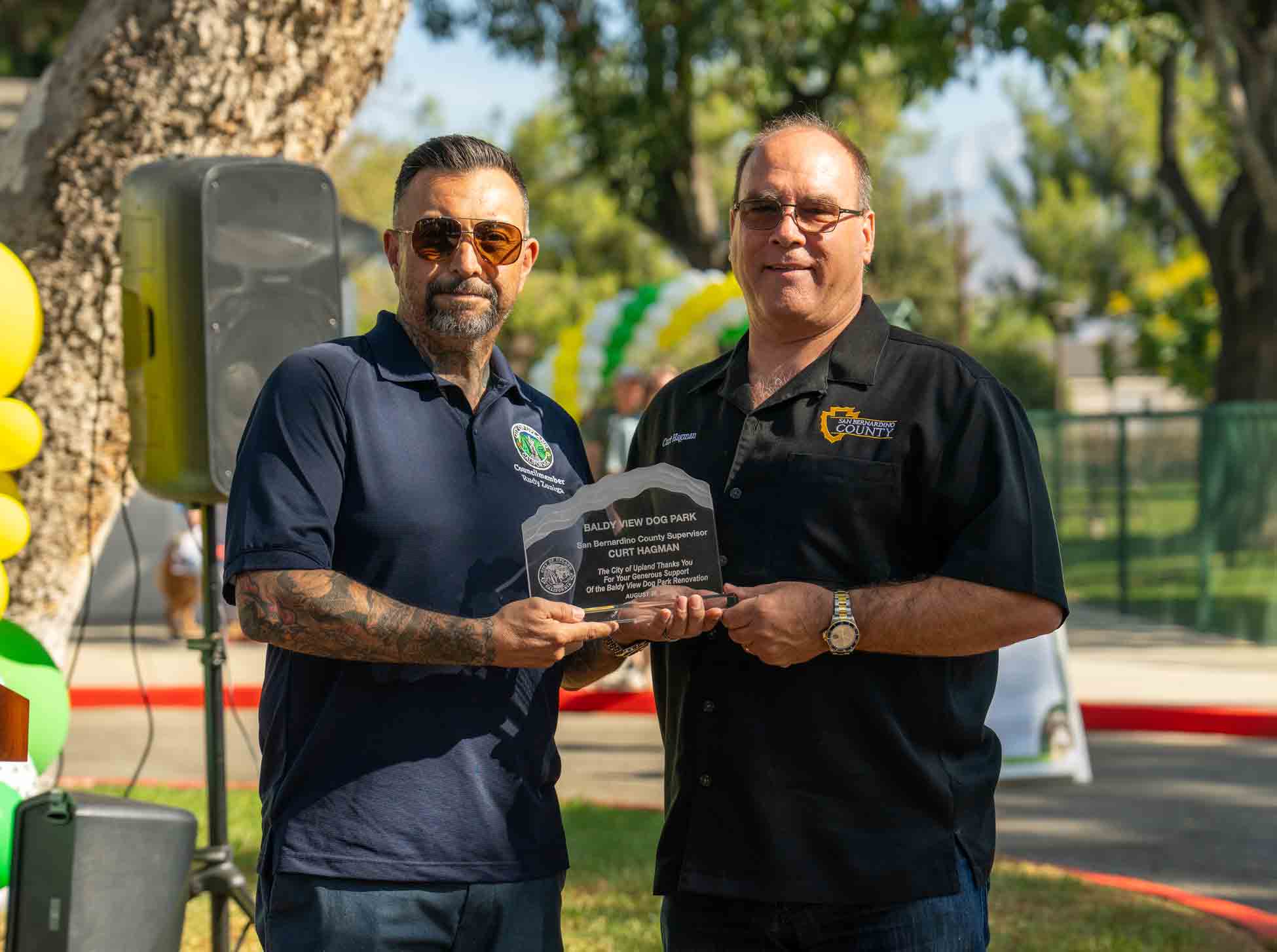 Supervisor Curt Hagman accepting an award from Upland City Councilmember Rudy Zuniga for his generous support of the Baldy View Dog Park Renovation Project.