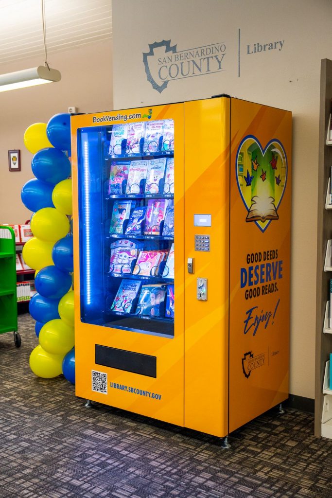 Bright yellow book vending machine installed at San Bernardino County Library.