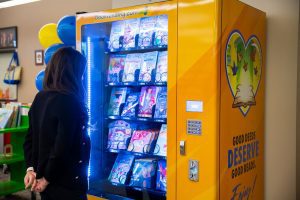 Woman viewing children’s book vending machine at San Bernardino County Library.