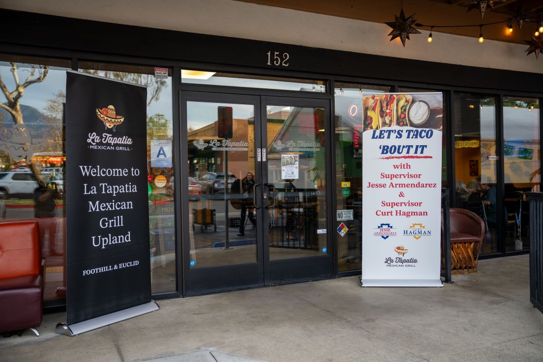 La Tapatia Mexican Grill storefront with banners welcoming guests to the Let’s Taco ’Bout It event.