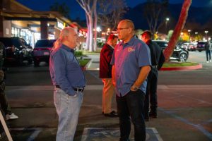Supervisor Hagman speaking to a male in a blue long sleeve shirt and jeans outside of La Tapatia Mexican Grill in Upland.