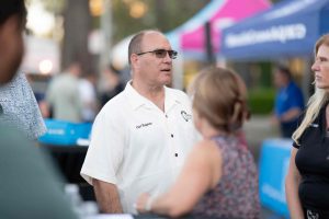 Curt Hagman speaks with community members at an outdoor Summer Open House event.