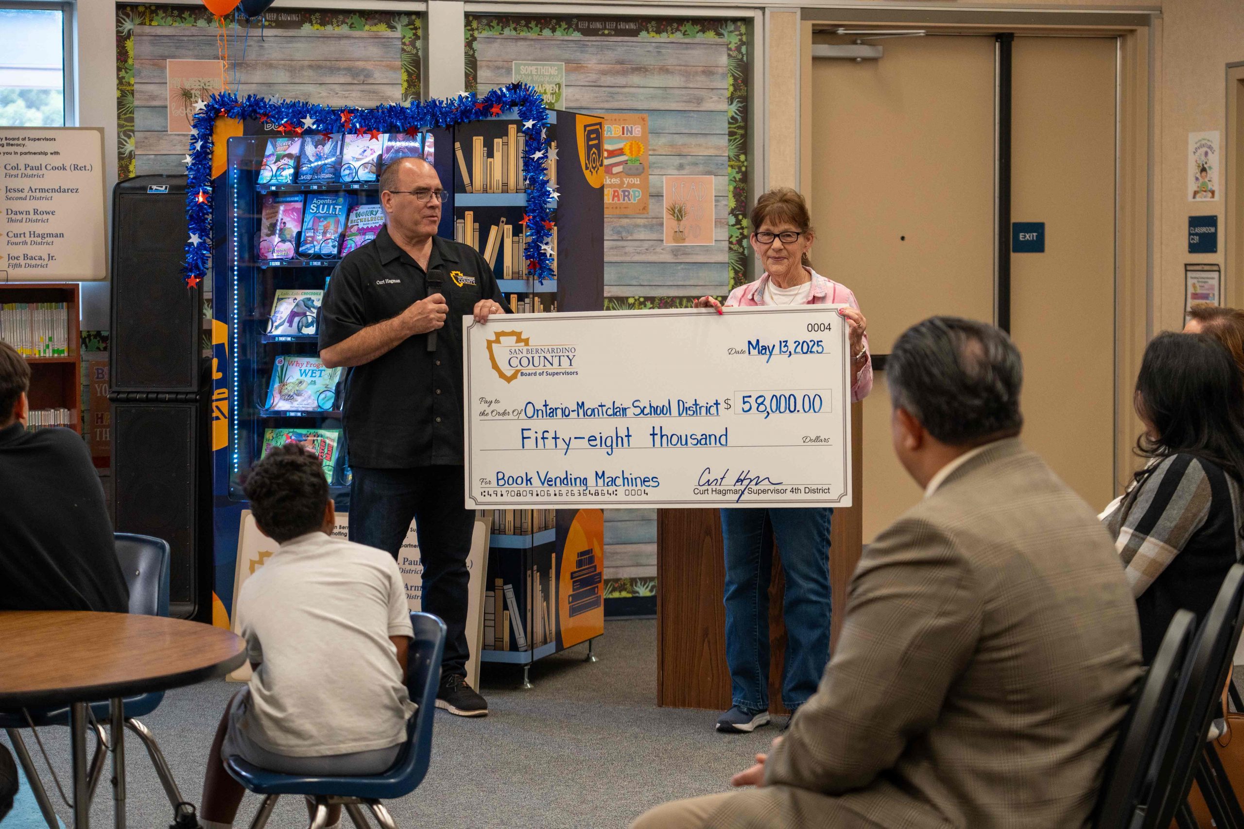 Supervisor Curt Hagman presents $58,000 check to OMSD for book vending machines.