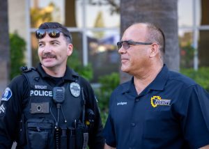 Supervisor Curt Hagman speaks with a local police officer during a community event in San Bernardino County.
