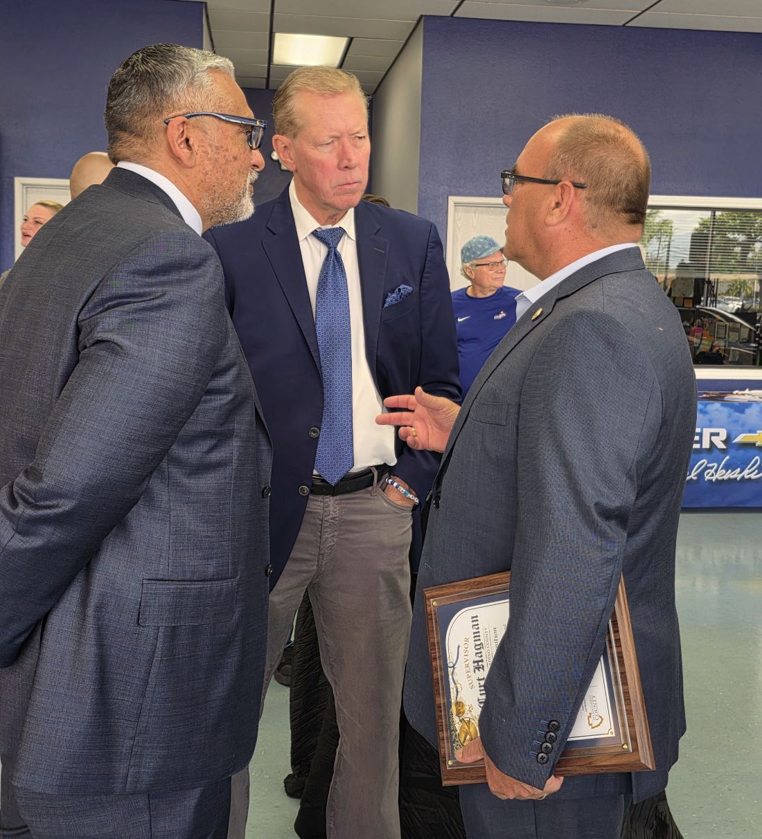 Supervisor Hagman speaks with attendees during a grand opening event at Orel Hershiser Chevrolet.