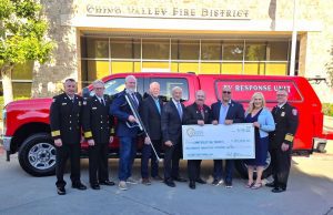 Fire officials and community leaders present a $125,000 check beside the new Chino Valley EV Response Unit.