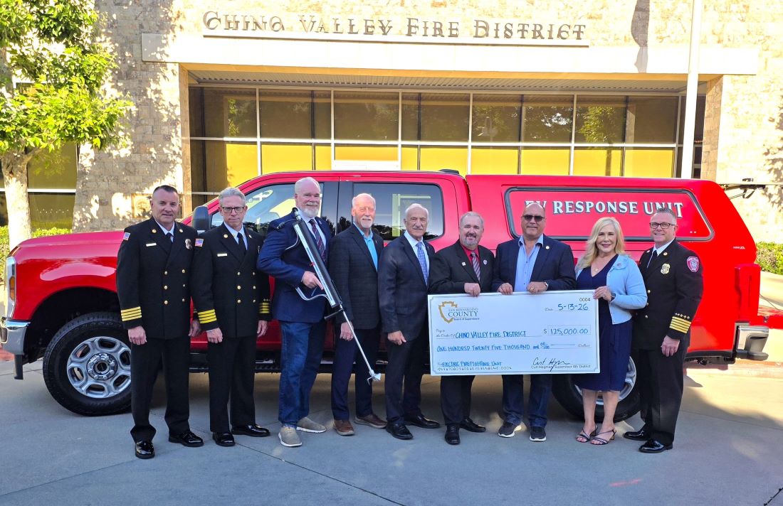 Fire officials and community leaders present a $125,000 check beside the new Chino Valley EV Response Unit.