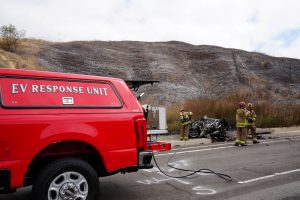 Chino Valley Fire's EV Response Unit assists firefighters at the scene of a damaged electric vehicle.