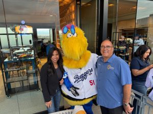 Supervisor Curt Hagman and his wife pose with the Ontario Tower Buzzer mascot at an ONT Field for 2026 Opening Day.