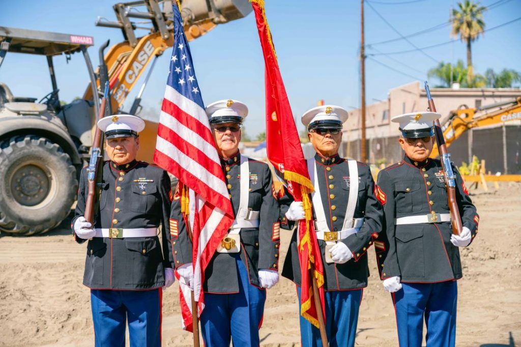U.S. Marine Corps color guard presents flags at veterans housing groundbreaking ceremony.