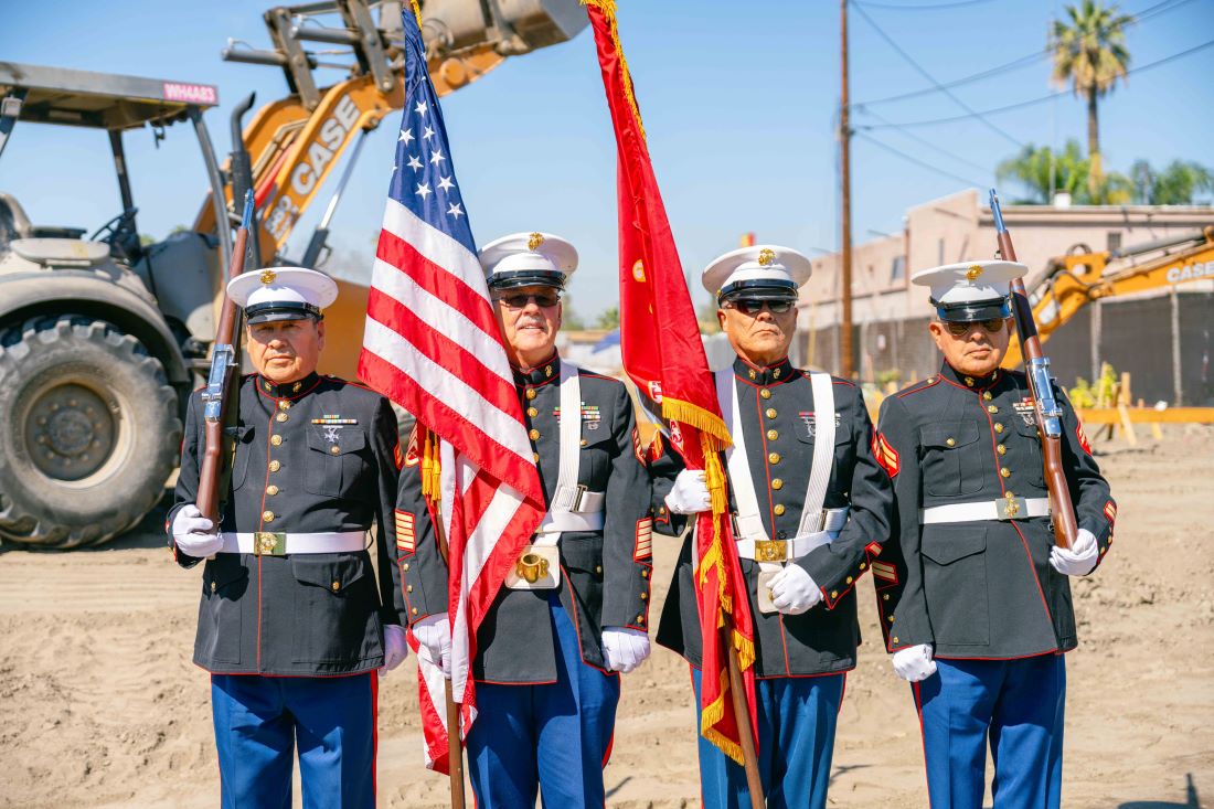 U.S. Marine Corps color guard presents flags at veterans housing groundbreaking ceremony.