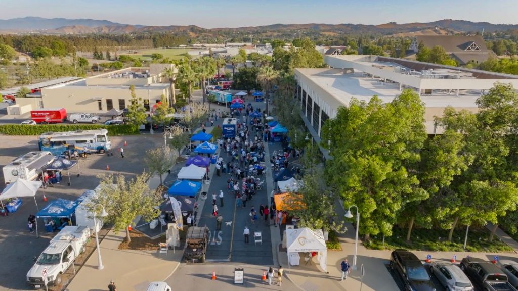 Aerial view of the Fourth District Summer Open House with community booths, resources, and attendees.