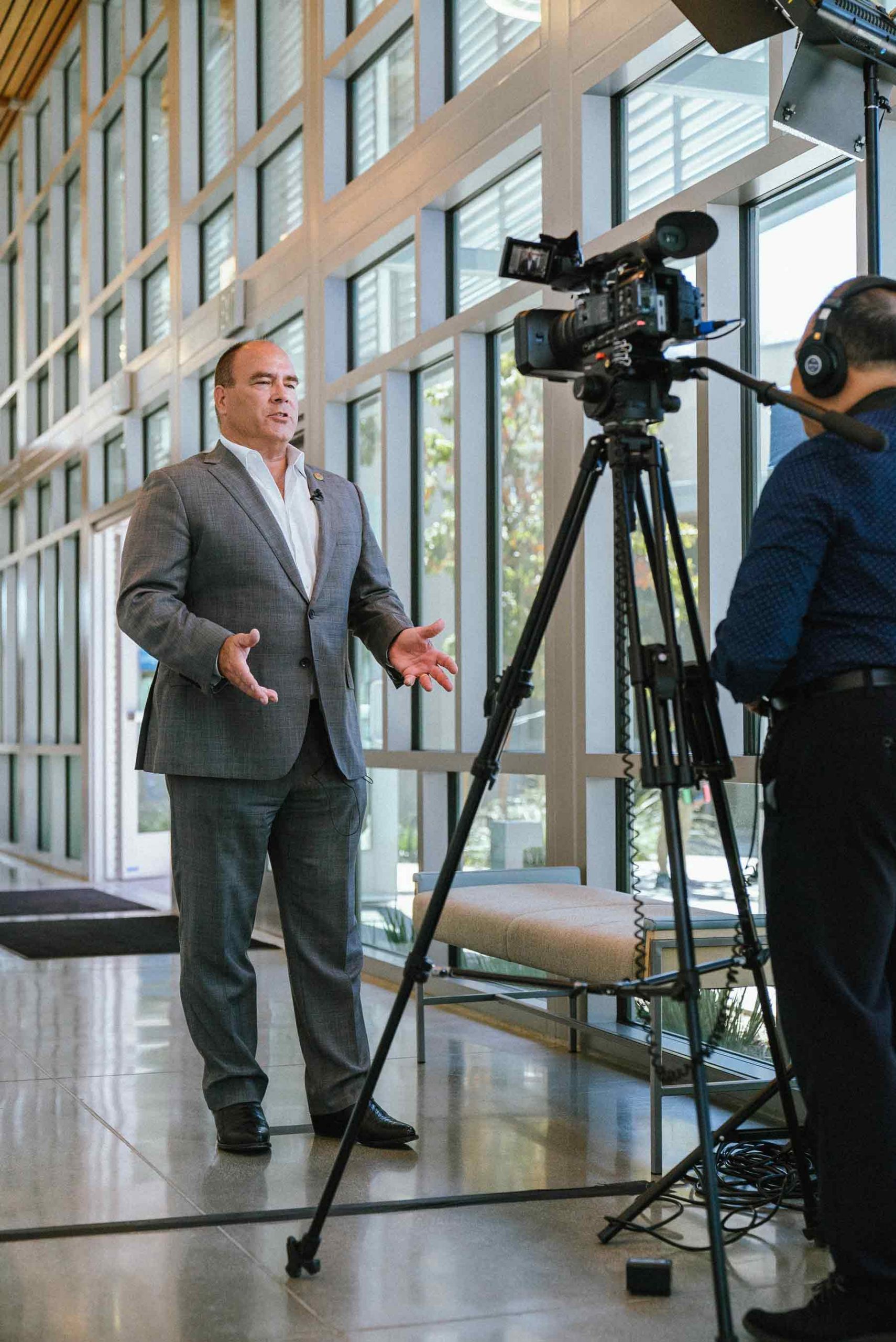 Supervisor Curt Hagman speaks on camera during an indoor interview at the 2022 West End Job Fair.