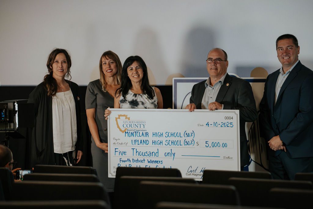 Group holding large check for $5,000 awarded to Montclair and Upland High Schools for contest win.