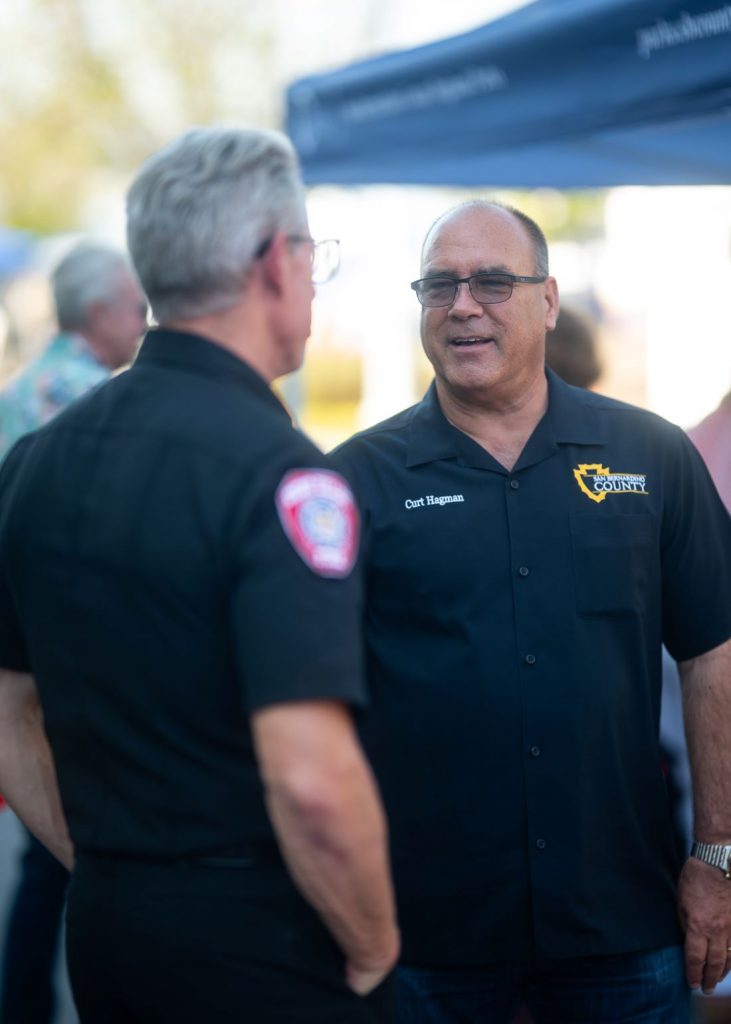 Supervisor Curt Hagman speaks with a Chino Valley firefighter during the Summer Open House.