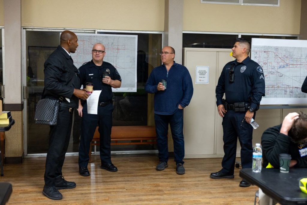 Supervisor Curt Hagman stands with police officers during the 2026 Point-In-Time Count briefing.