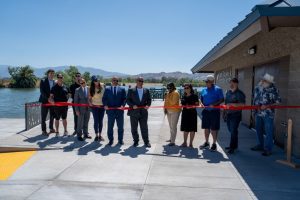 Community leaders hold a ribbon during the grand opening of the Snack Bar at Prado Regional Park.