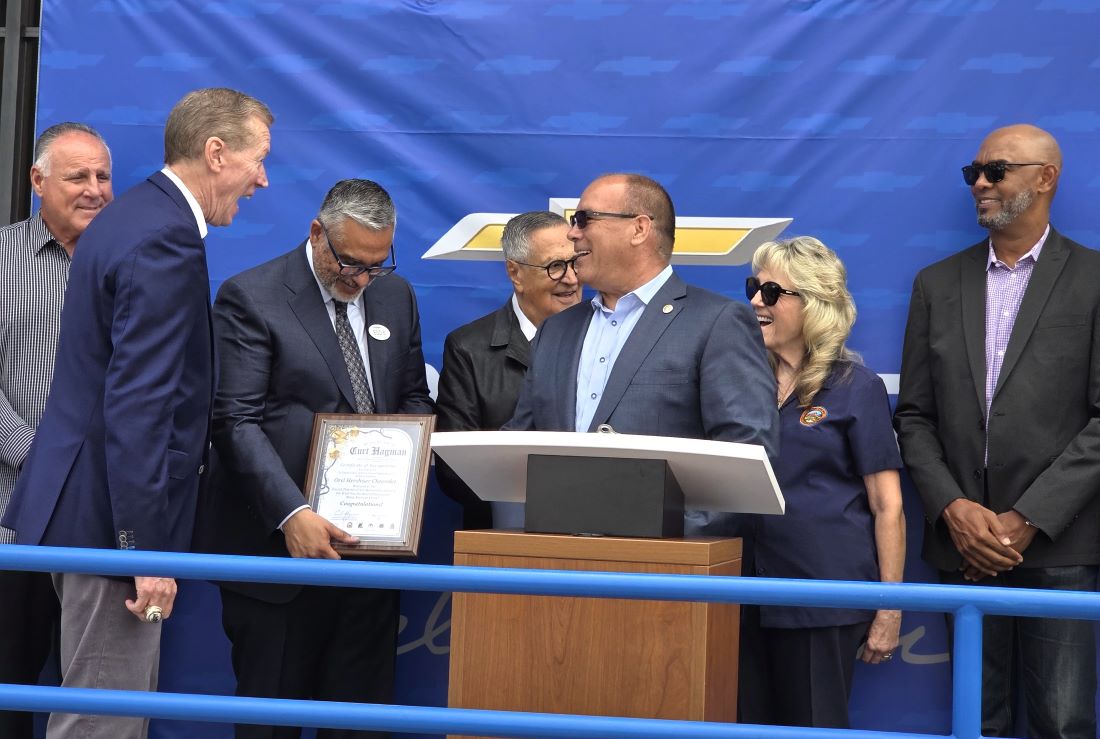 Supervisor Hagman presents a certificate during the Orel Hershiser Chevrolet grand opening ceremony.