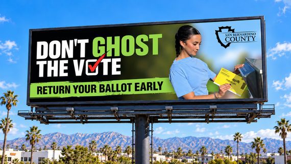 San Bernardino County billboard reads “Don’t Ghost the Vote — Return Your Ballot Early,” featuring a voter placing a ballot in a drop box.